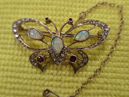 9CT GOLD BUTTERFLY BROOCH, OPALS AND RED STONES